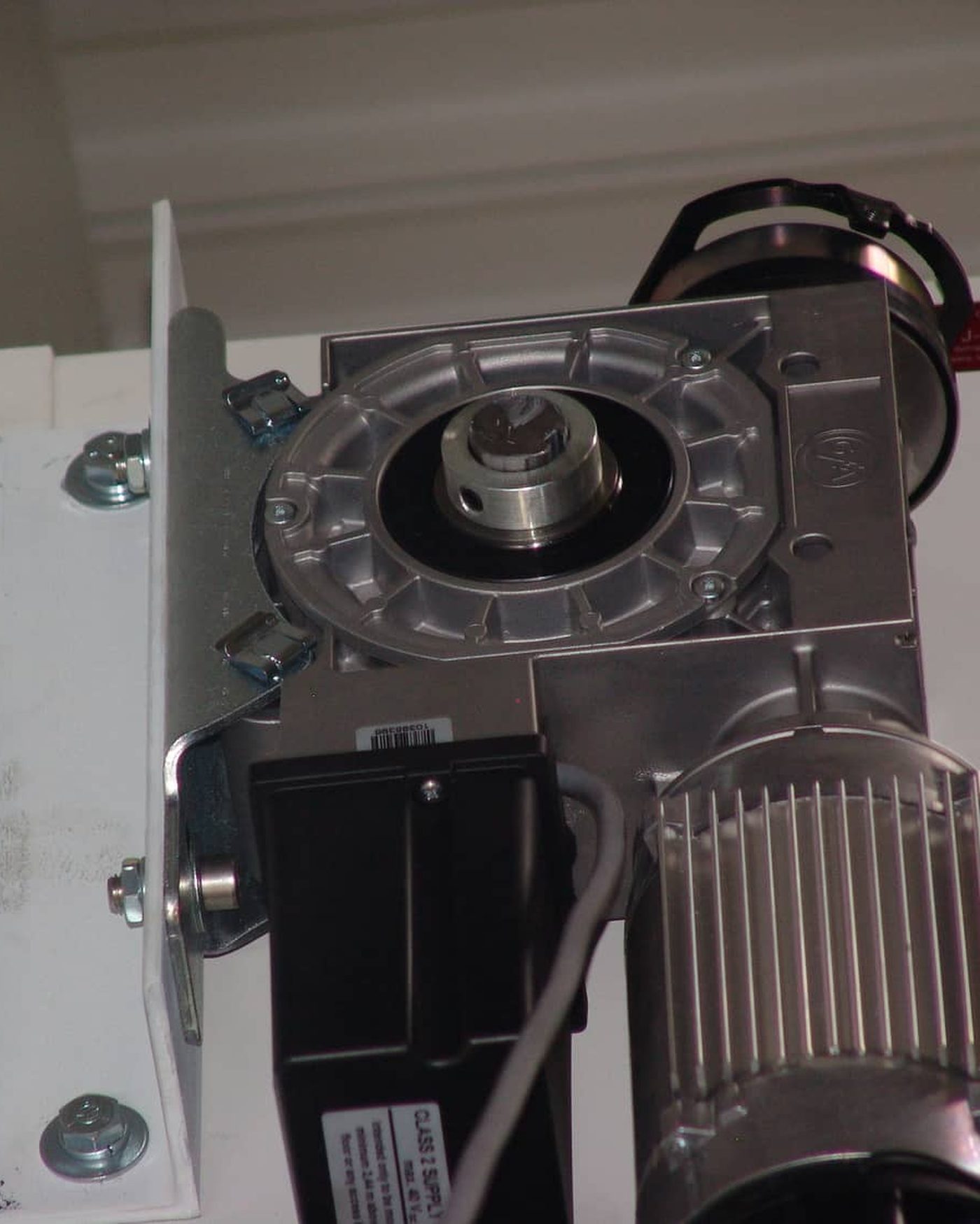 An industrial sectional door operator and drive unit of the kind installed on commercial overhead doors