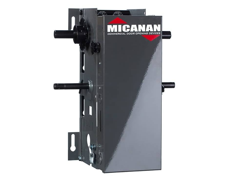 A Micanan jackshaft-type commercial door operator, the wall-mounted unit that drives the torsion shaft from beside the opening