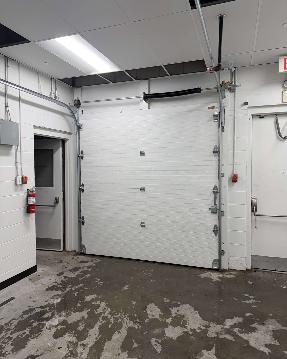 A commercial overhead door opening serviced by Canuck Door Systems