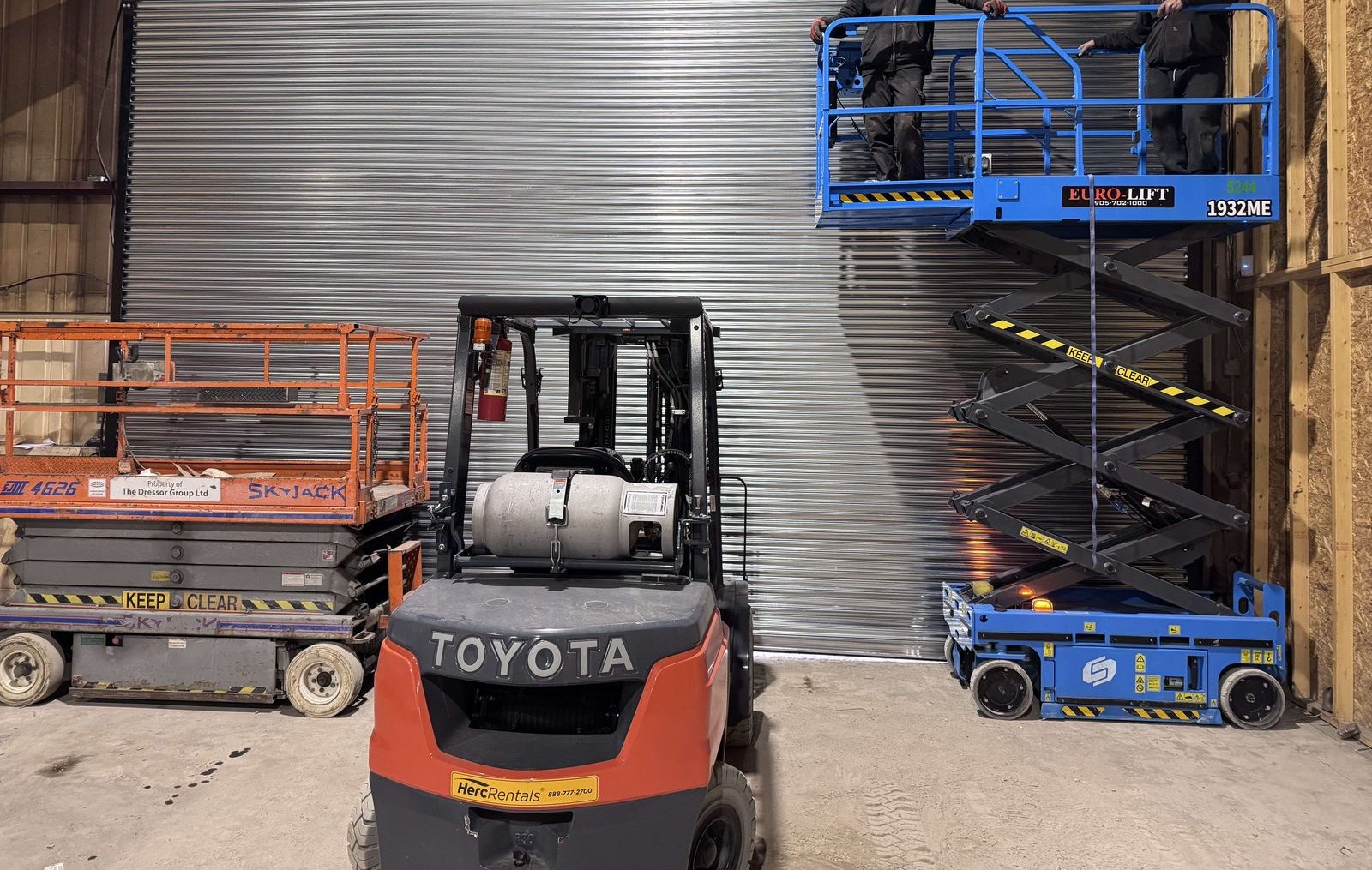 A rolling steel shutter installed in an industrial opening, with the curtain and guides visible, by Canuck Door Systems