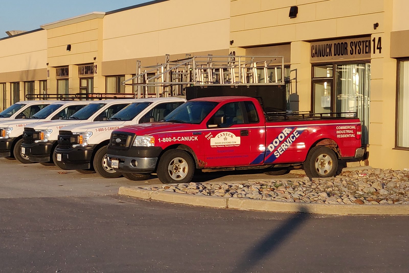 Canuck Door Systems service trucks parked outside the company's shop at unit 14, 1645 Bonhill Road, Mississauga