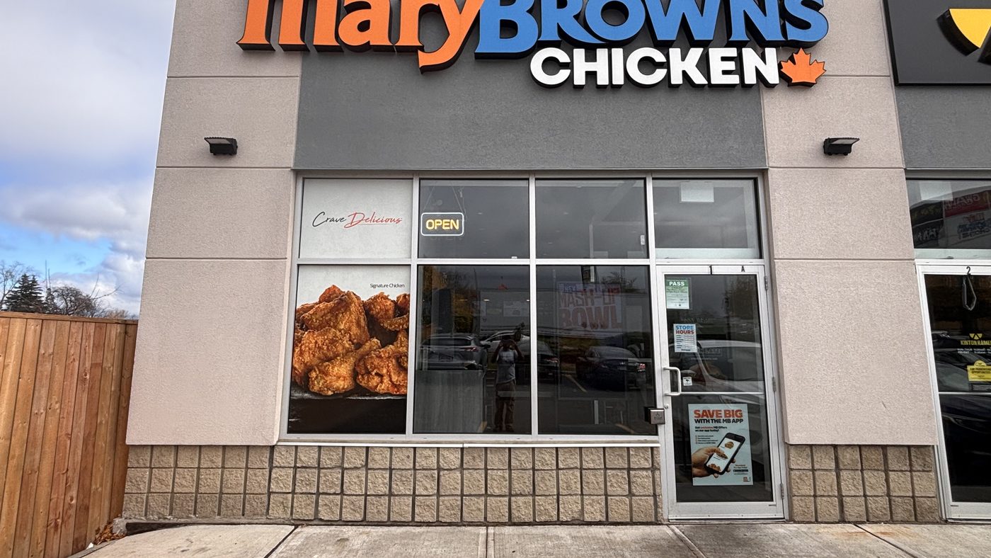 The end unit of the retail plaza at 1379 Upper James Street in Hamilton, with a new aluminum storefront and entrance door under a restaurant sign