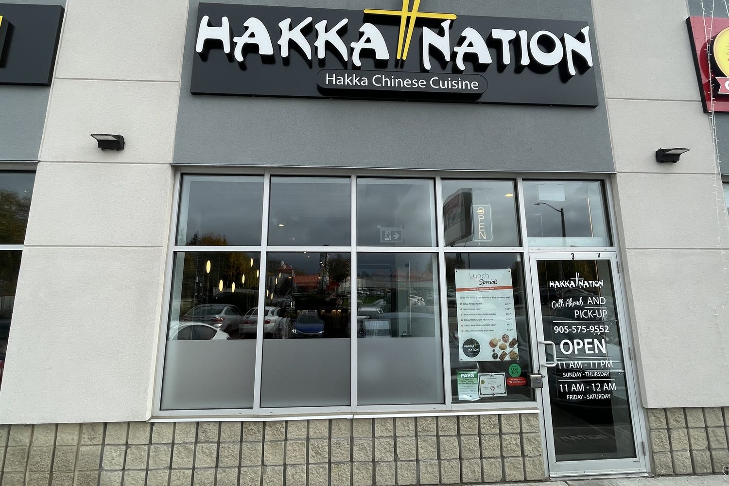 A new aluminum storefront with a glazed entrance door and windows under a Chinese restaurant sign at the plaza at 1379 Upper James Street, Hamilton