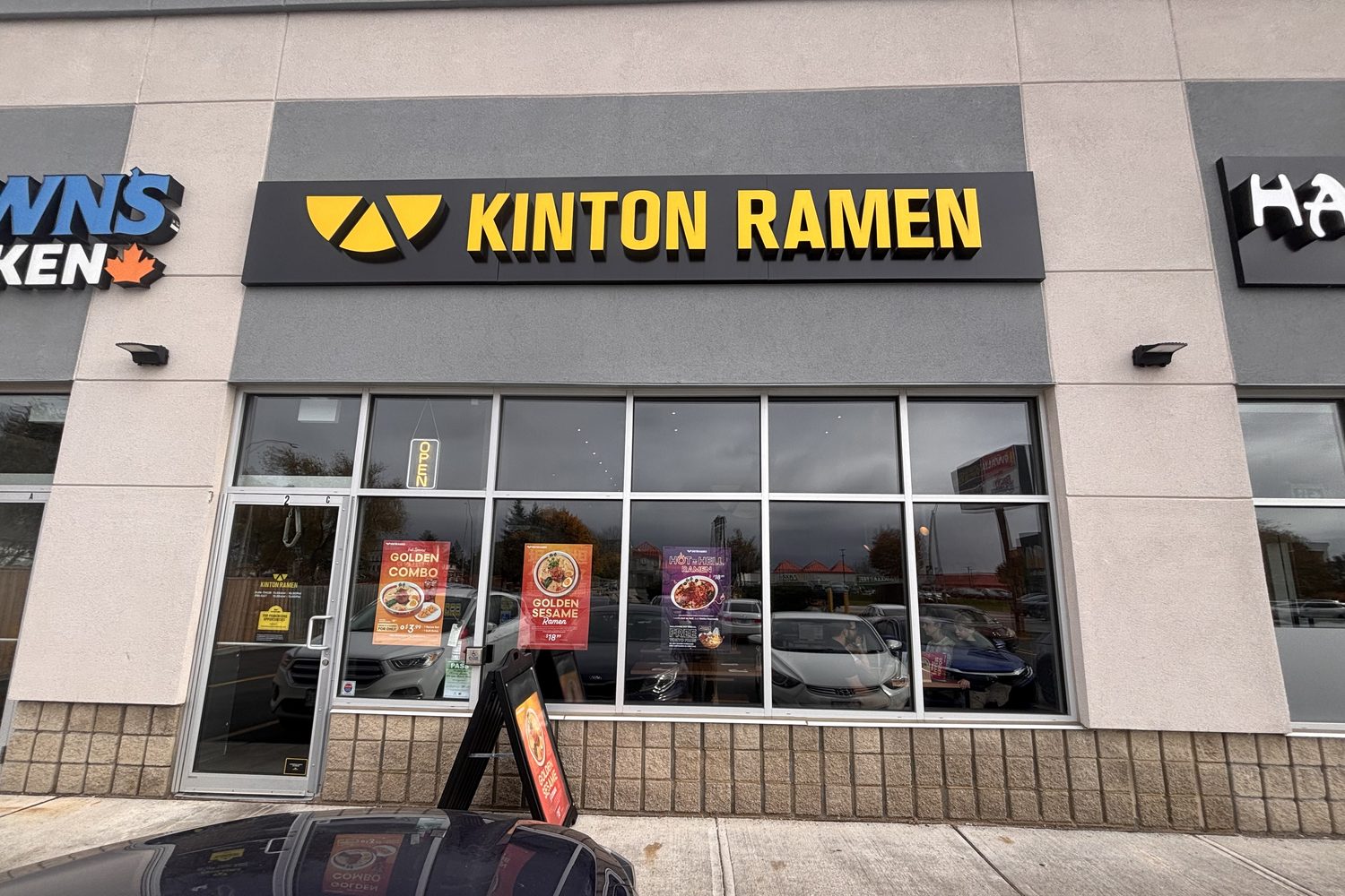 A new aluminum storefront with a row of windows under a ramen restaurant sign at the plaza at 1379 Upper James Street, Hamilton