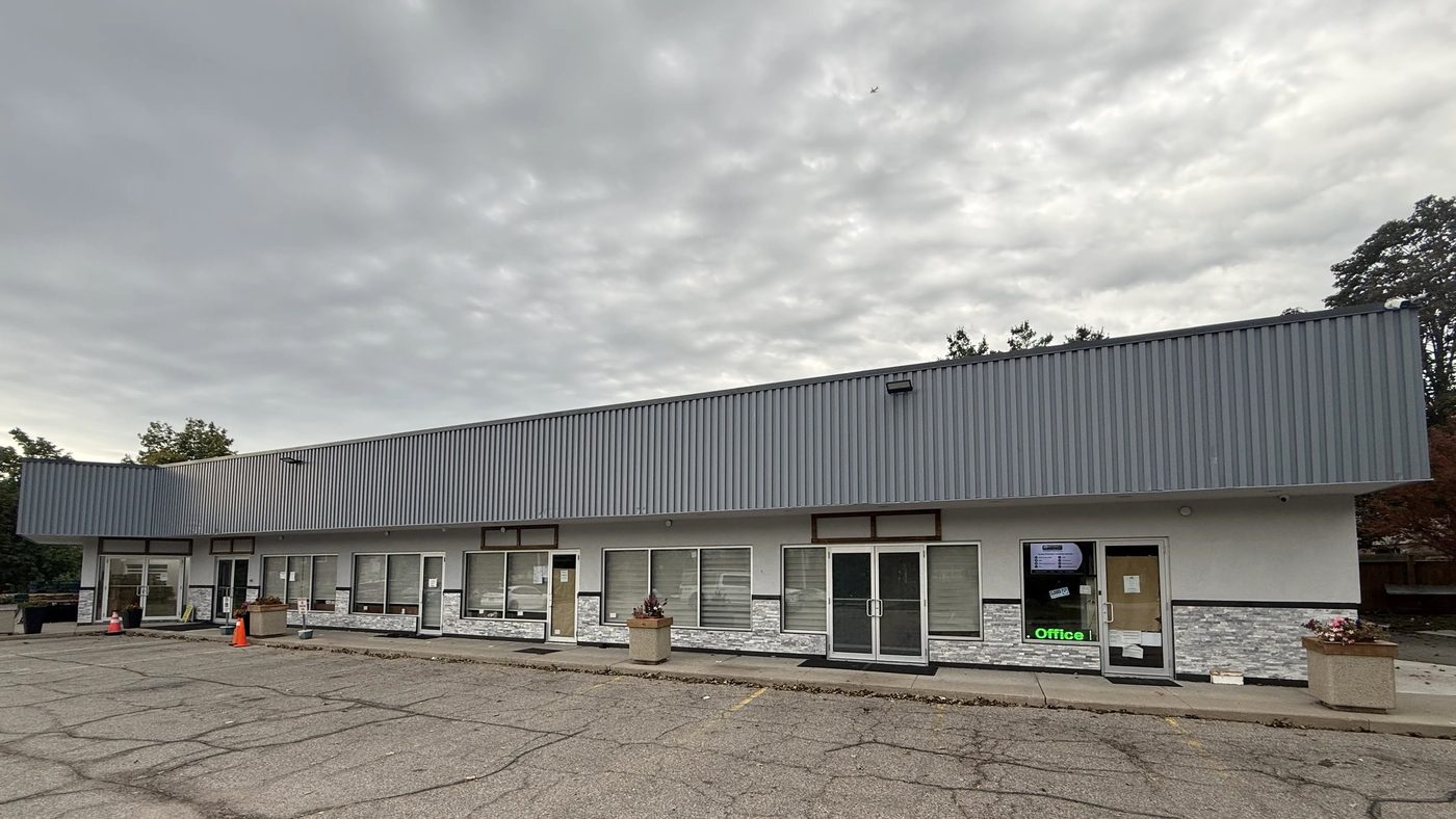 The full front of the single-storey plaza at 6120 Montevideo Road, Mississauga, with new aluminum storefront doors and windows along every unit under a long grey metal fascia