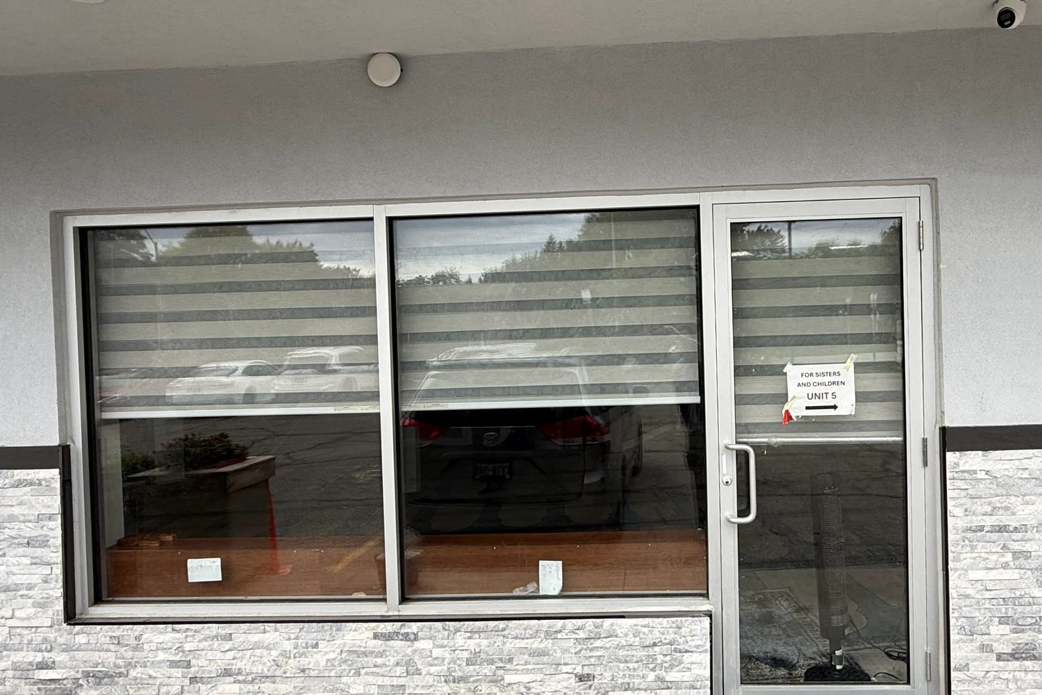 Another unit at the Mississauga plaza with a wide new aluminum storefront window and a single glass-and-aluminum entrance door, installed by Canuck Door Systems