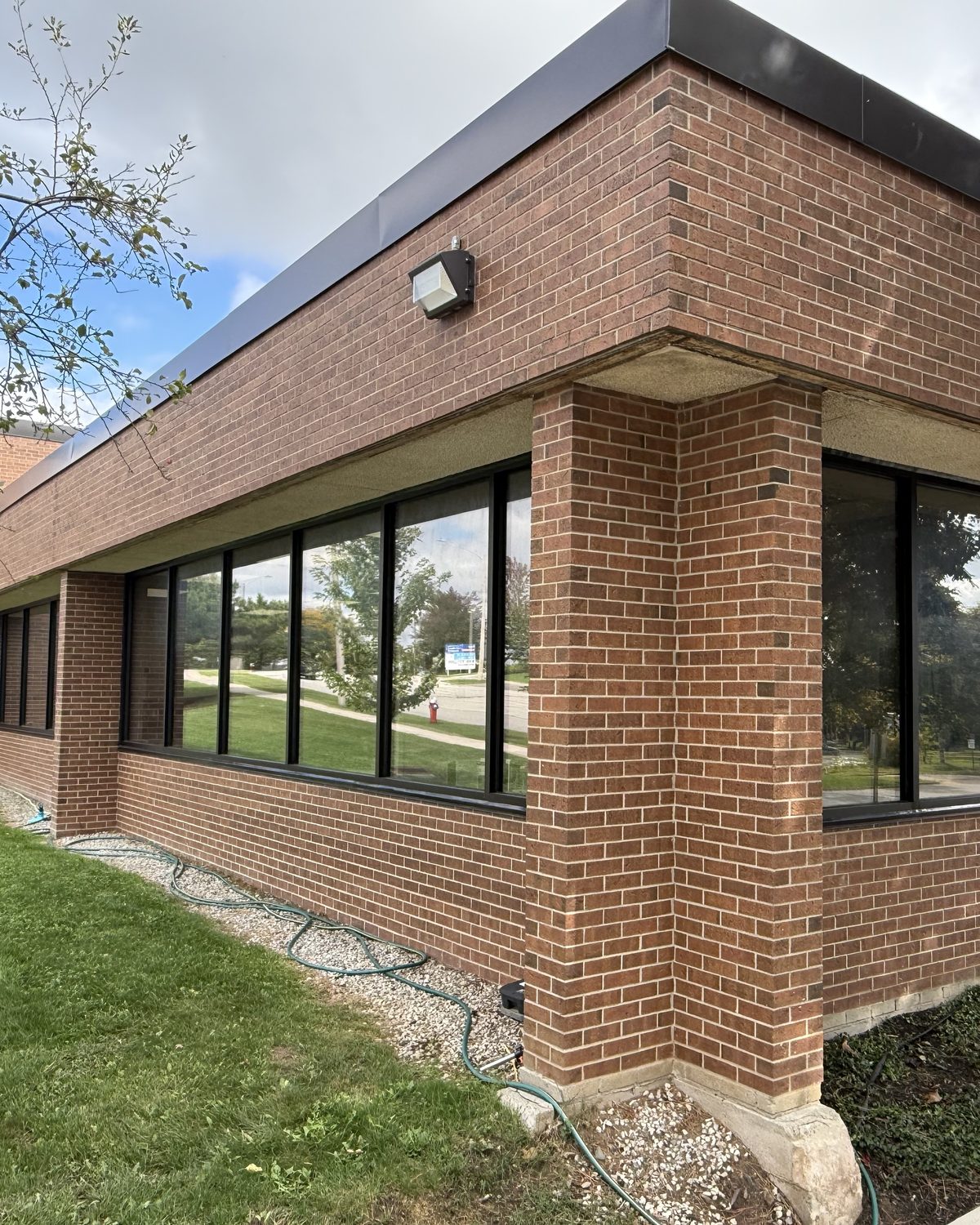 The corner of PCI Pharma Services' brick building in Mississauga, with new aluminum windows running along both walls