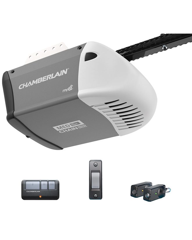 A chain-drive garage door opener head unit with its rail, shown with a remote, a wall console and a pair of safety photo eyes