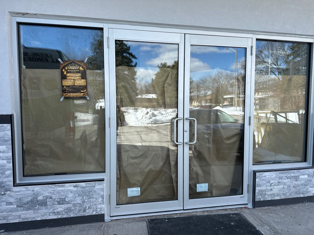 Aluminum storefront entrance doors installed by Canuck Door Systems for ICNA Relief Canada in Mississauga